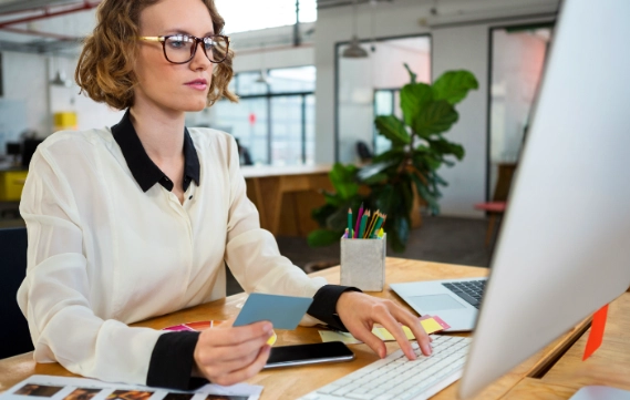 Woman at desk reviewing print documents